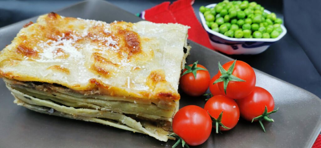 Capas doradas y gratinadas de pasta con relleno cremoso de calabacín y brócoli para Lasaña Vegetariana